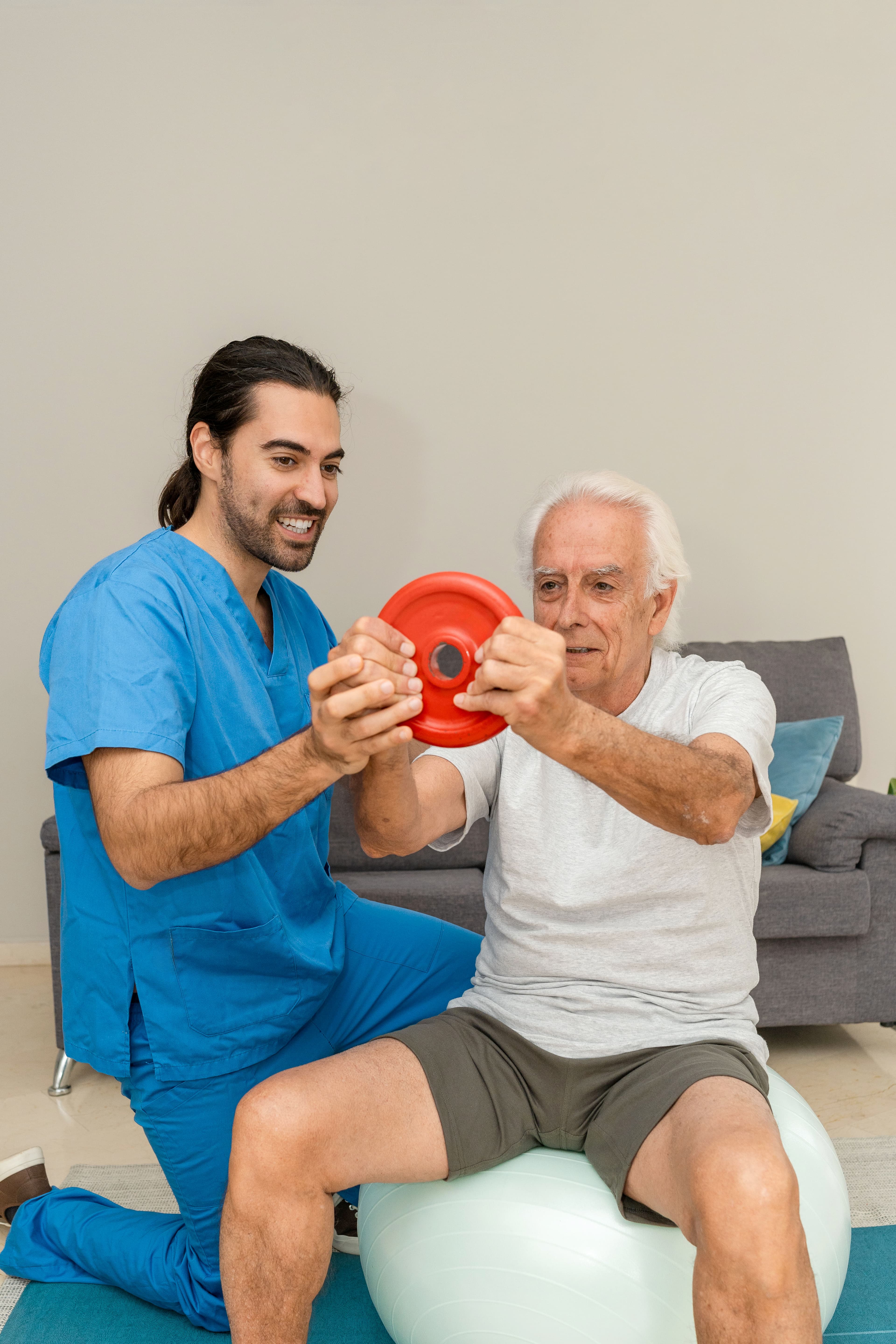 Physiotherapist guiding a patient through dumbbell exercises